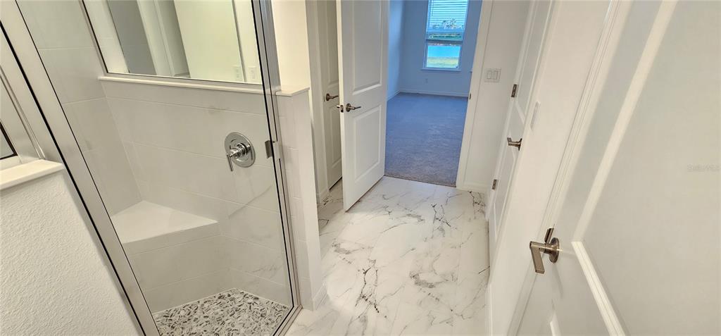 4233 Pond Brk Court Lakewood Ranch, FL 34211 - Photo 20 of 49 a bathroom with a tub and a shower