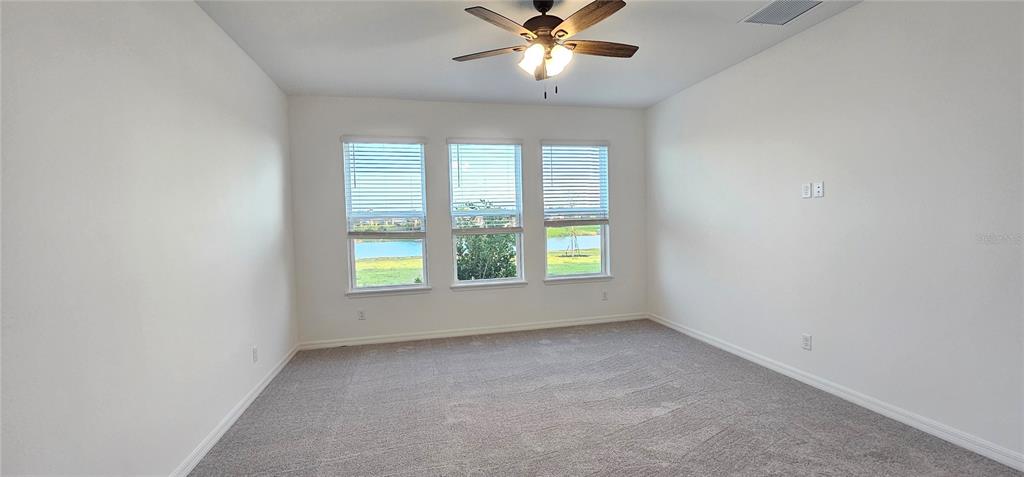 4233 Pond Brk Court Lakewood Ranch, FL 34211 - Photo 21 of 49 an empty room with a window and a fan