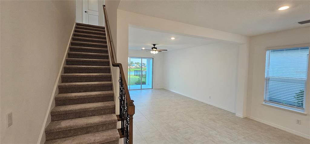 4233 Pond Brk Court Lakewood Ranch, FL 34211 - Photo 22 of 49 wooden floor in an empty room with stairs