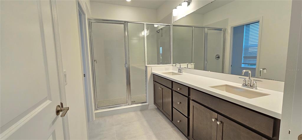 4233 Pond Brk Court Lakewood Ranch, FL 34211 - Photo 24 of 49 a bathroom with double vanity sink and a mirror