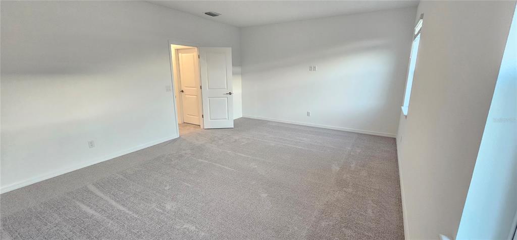 4233 Pond Brk Court Lakewood Ranch, FL 34211 - Photo 30 of 49 an empty room with a window and a mirror
