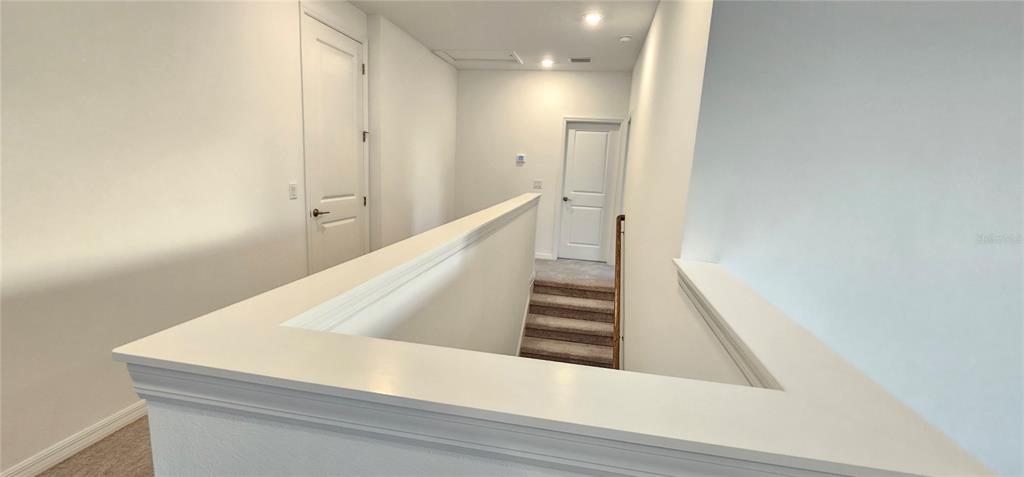 4233 Pond Brk Court Lakewood Ranch, FL 34211 - Photo 32 of 49 a view of a hallway with staircase