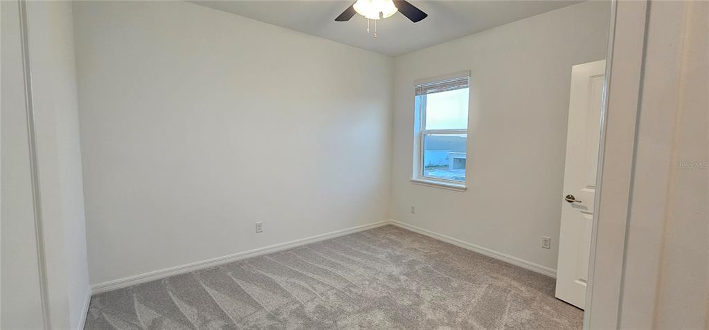 4233 Pond Brk Court Lakewood Ranch, FL 34211 - Photo 35 of 49 an empty room with a window and a chandelier fan