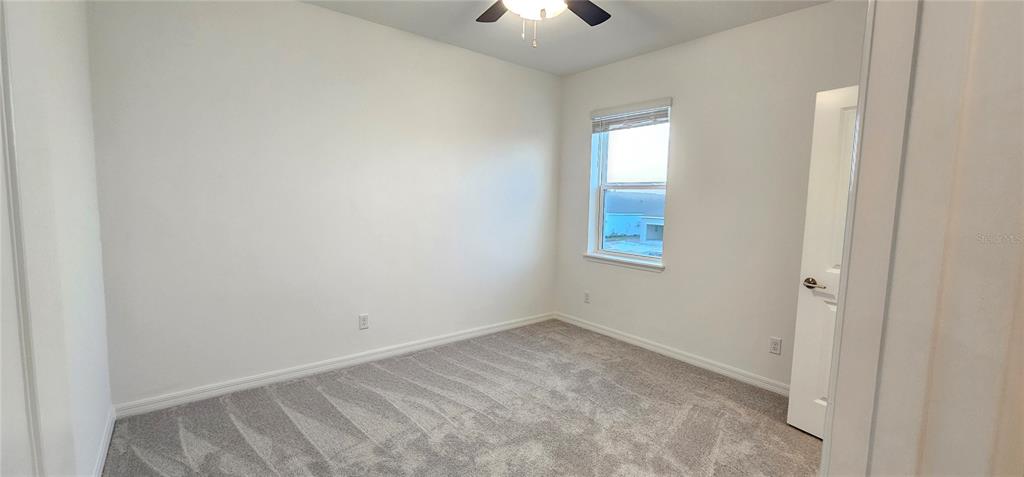 4233 Pond Brk Court Lakewood Ranch, FL 34211 - Photo 36 of 49 an empty room with a window and a fan