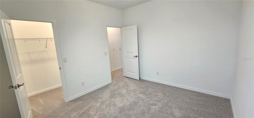 4233 Pond Brk Court Lakewood Ranch, FL 34211 - Photo 37 of 49 an empty room with a door
