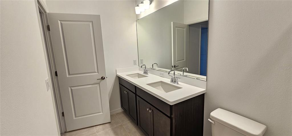 4233 Pond Brk Court Lakewood Ranch, FL 34211 - Photo 45 of 49 a bathroom with a sink and a toilet