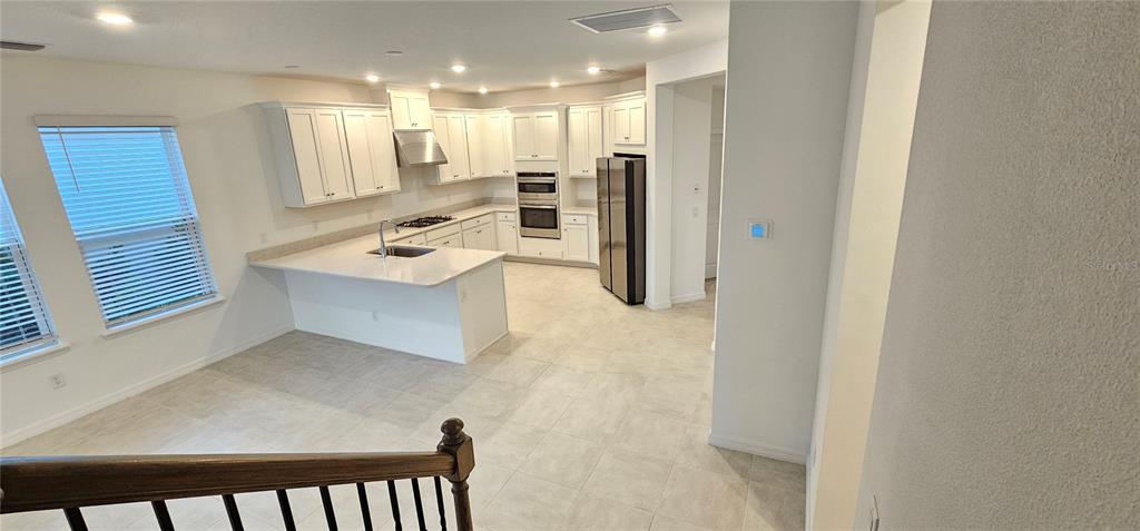 4233 Pond Brk Court Lakewood Ranch, FL 34211 - Photo 46 of 49 a view of a kitchen with a refrigerator and a sink