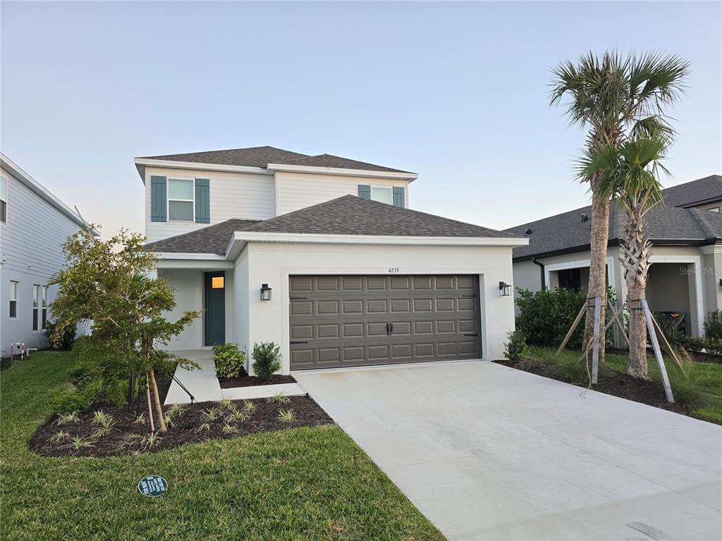 4233 Pond Brk Court Lakewood Ranch, FL 34211 - Photo 48 of 49 a front view of a house with a yard and potted plants