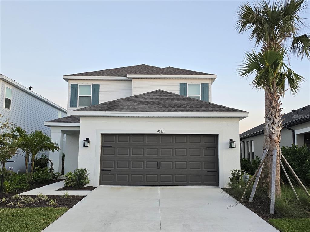 4233 Pond Brk Court Lakewood Ranch, FL 34211 - Photo 49 of 49 a front view of a house with a yard and garage