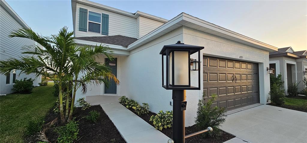 4233 Pond Brk Court Lakewood Ranch, FL 34211 - Photo 6 of 49 a front view of a house with a yard
