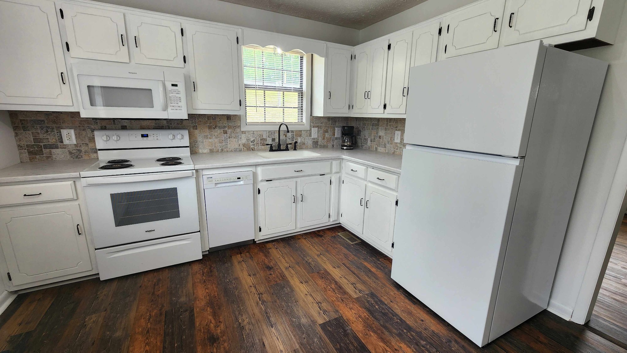 1825 Free Hill Road Celina, TN 38551 - Photo 14 of 49 a kitchen with granite countertop white cabinets and white appliances