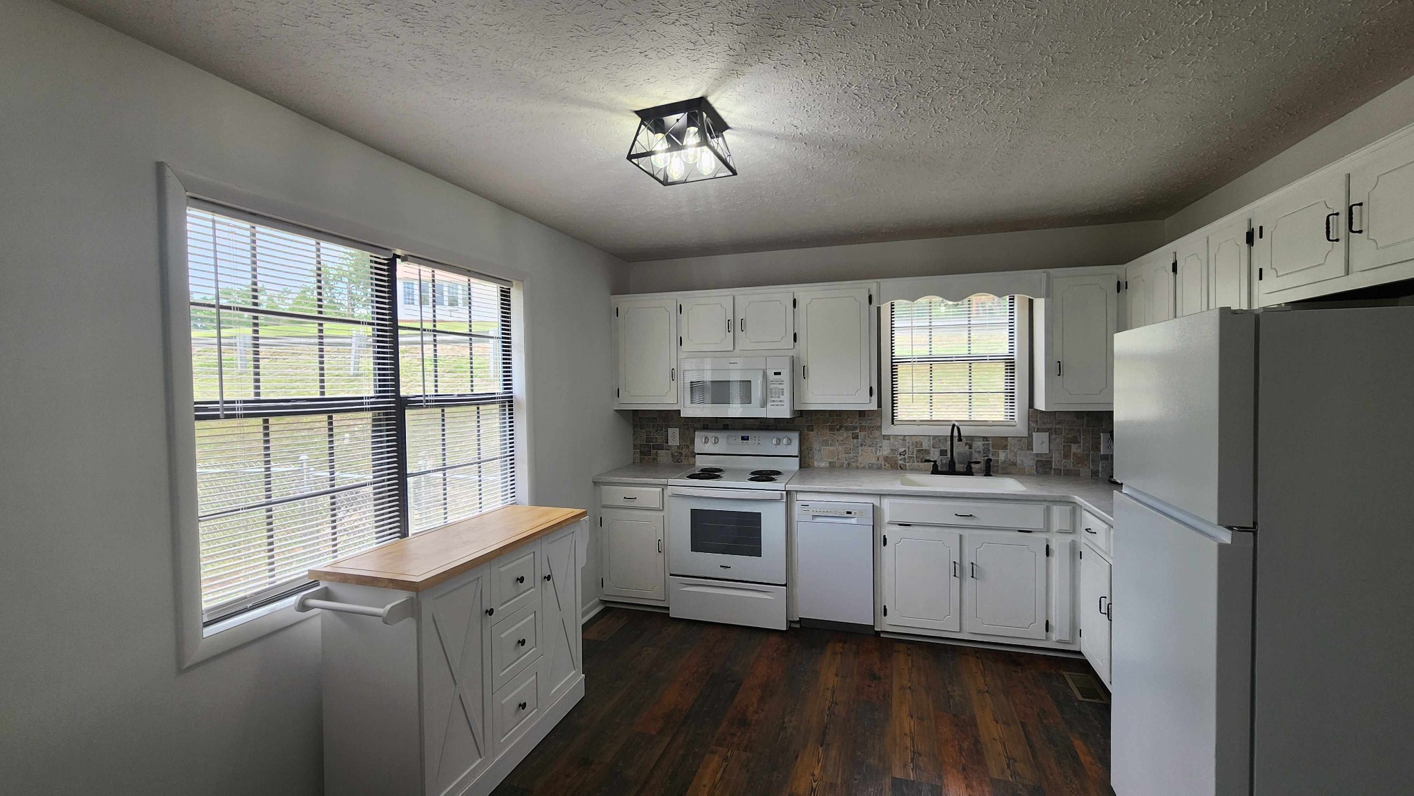 1825 Free Hill Road Celina, TN 38551 - Photo 16 of 49 a kitchen with stainless steel appliances a sink cabinets and a window