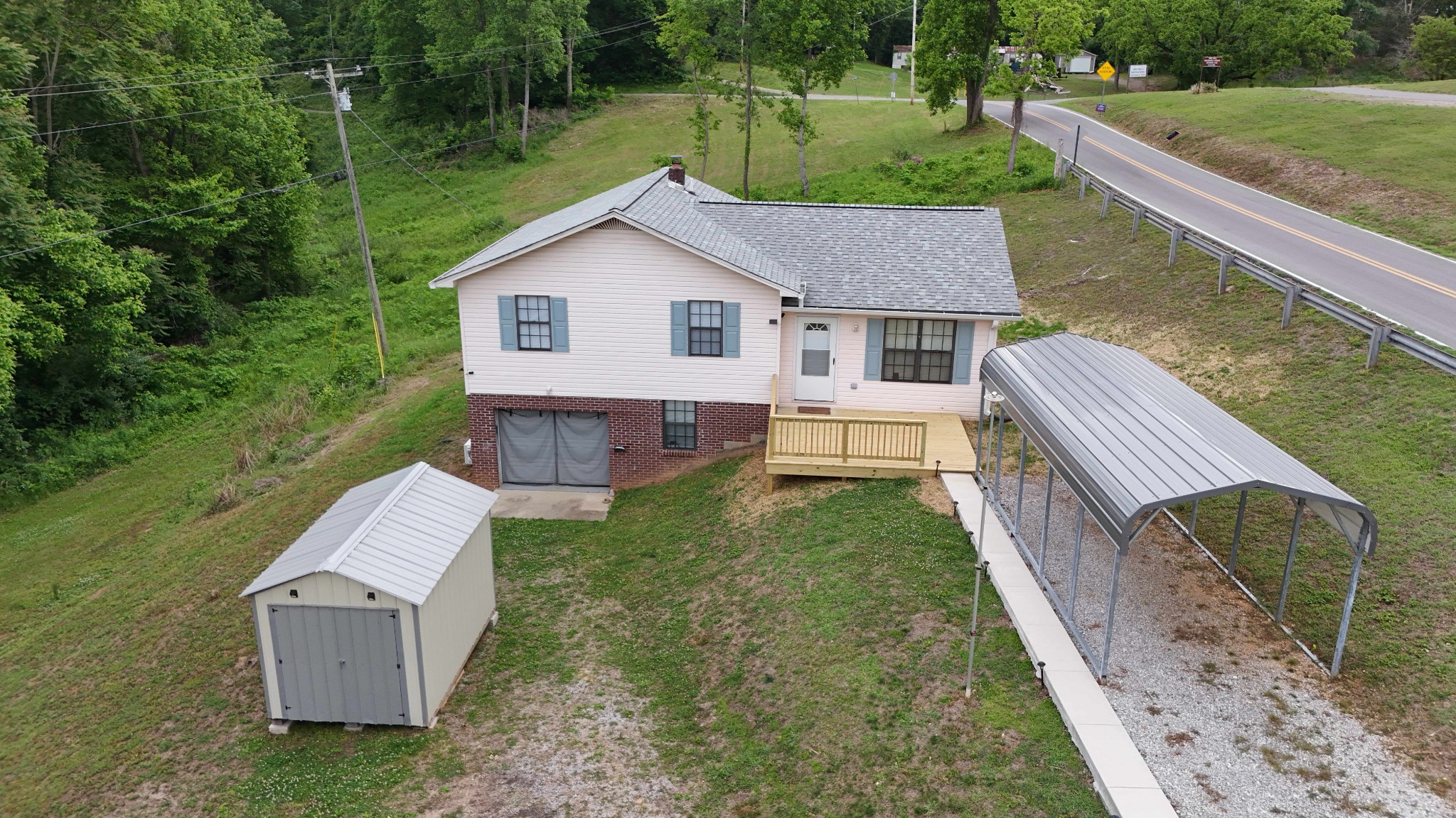 1825 Free Hill Road Celina, TN 38551 - Photo 28 of 49 a view of a house with a yard and a garden