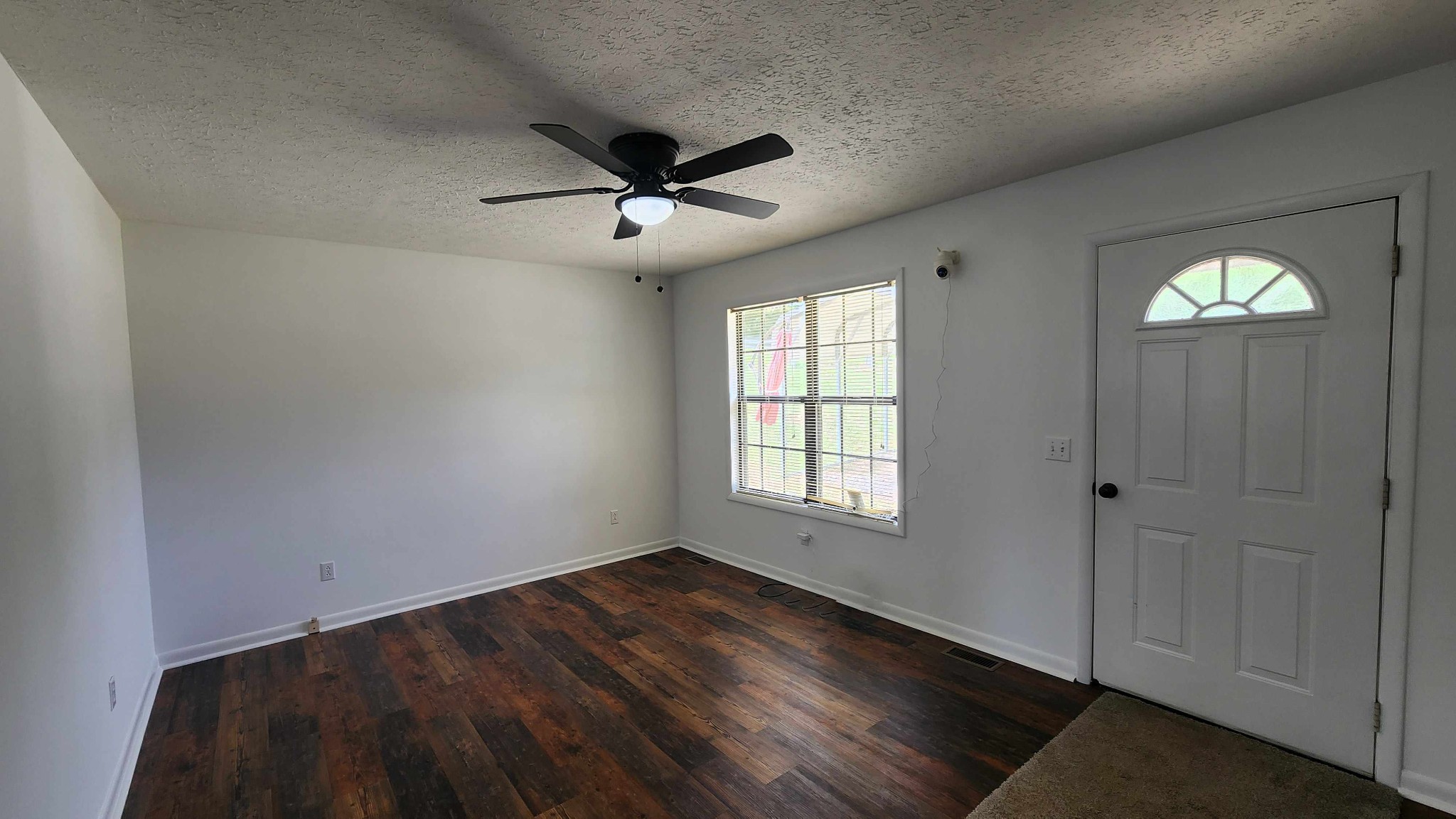 1825 Free Hill Road Celina, TN 38551 - Photo 3 of 49 a view of empty room with wooden floor and fan