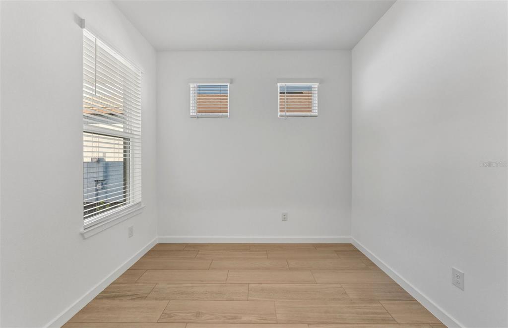 13764 Rocky Pne Place Spring Hill, FL 34610 - Photo 12 of 29 a view of empty room with wooden floor and fan