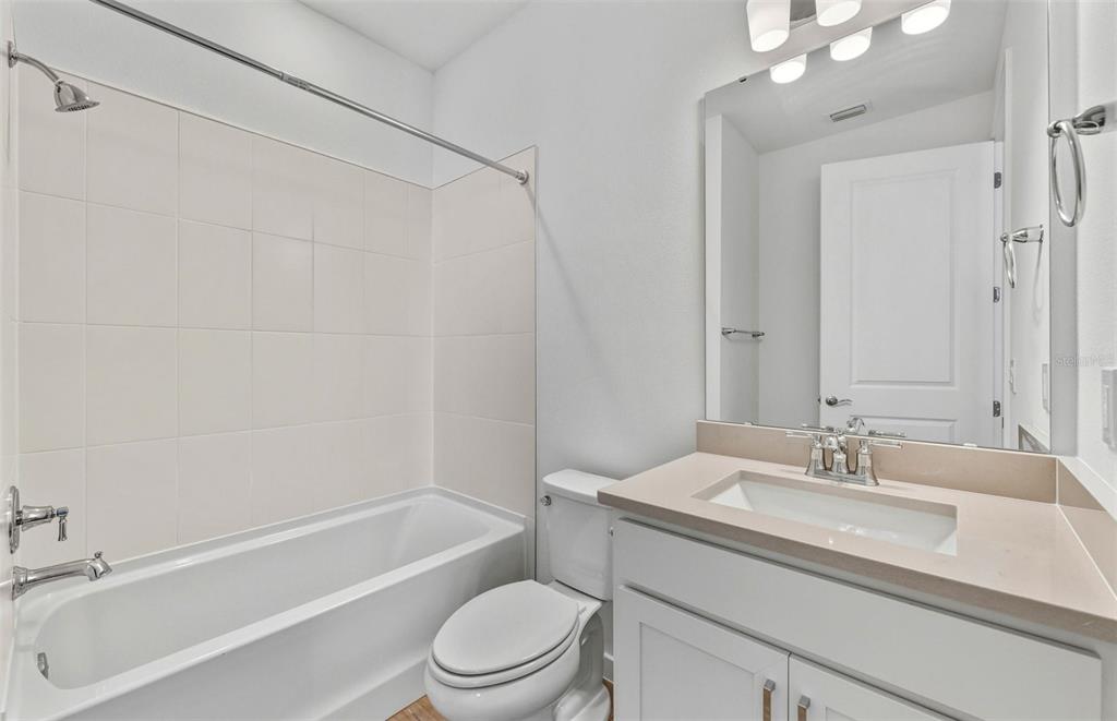 13764 Rocky Pne Place Spring Hill, FL 34610 - Photo 14 of 29 a bathroom with a granite countertop sink a toilet and shower