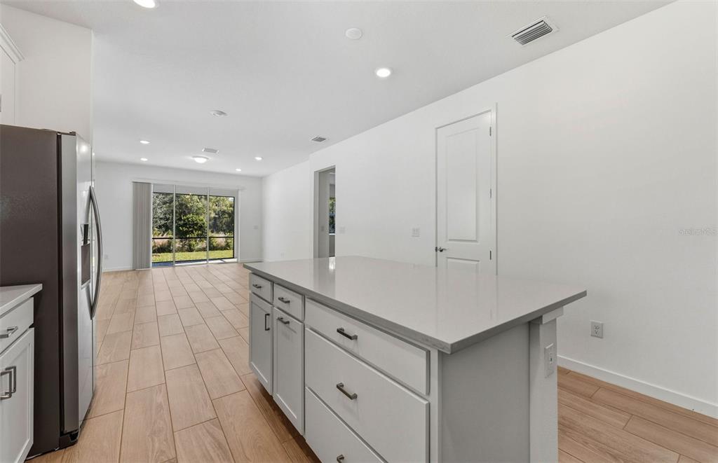 13764 Rocky Pne Place Spring Hill, FL 34610 - Photo 4 of 29 a kitchen with white cabinets and refrigerator
