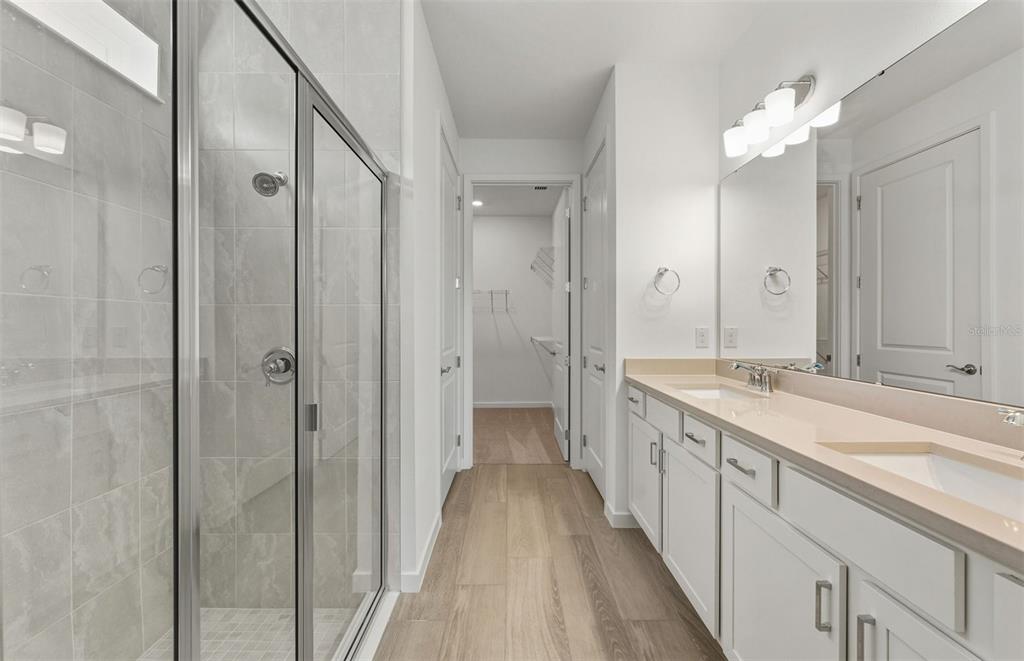 13764 Rocky Pne Place Spring Hill, FL 34610 - Photo 10 of 29 a spacious bathroom with a double vanity sink and mirror