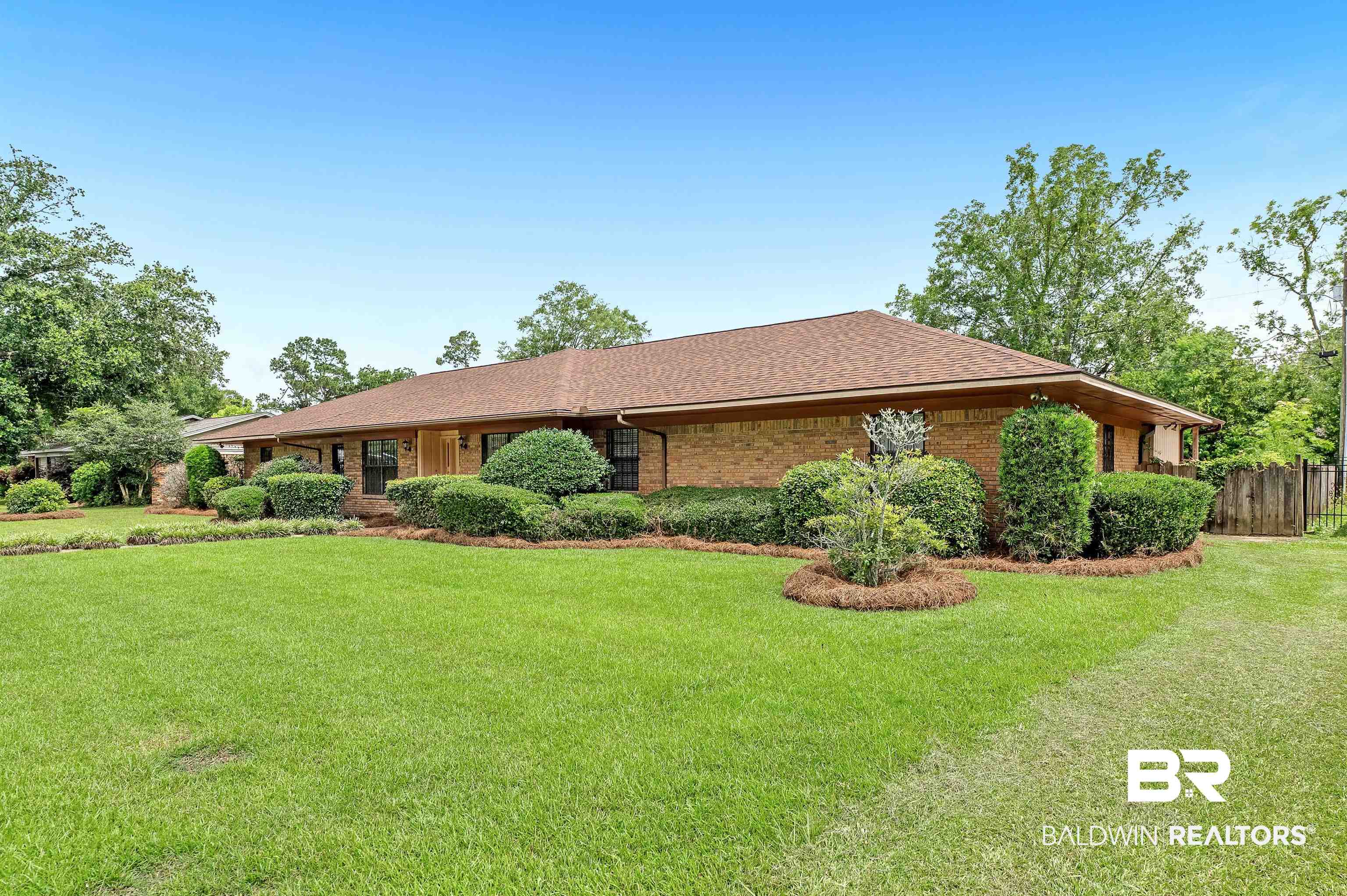 610 East Walker Avenue Foley, AL 36535 - Photo 1 of 38 View of front of property featuring brick siding and roof with shingles