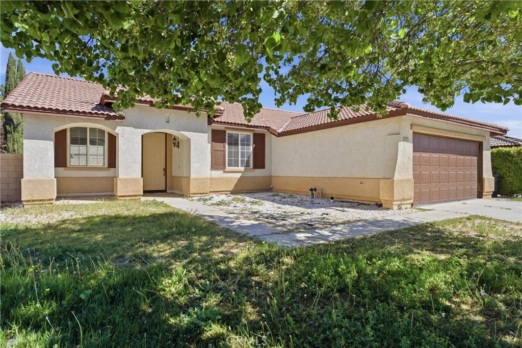 1555 Sutherland Street Lancaster, CA 93534 - Photo 1 of 1 a front view of a house with a garden