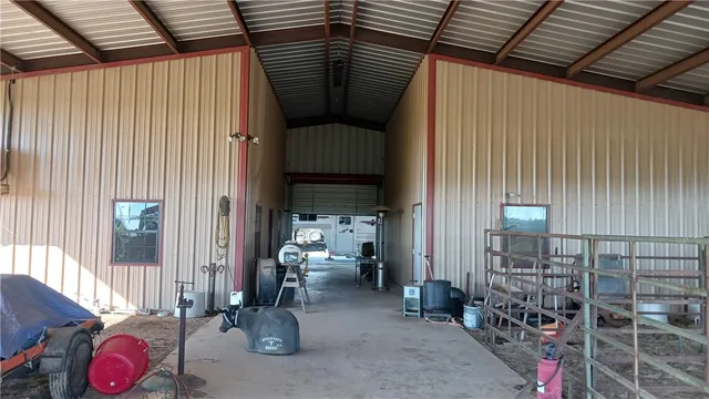 a view of a swimming pool with chairs in front of house