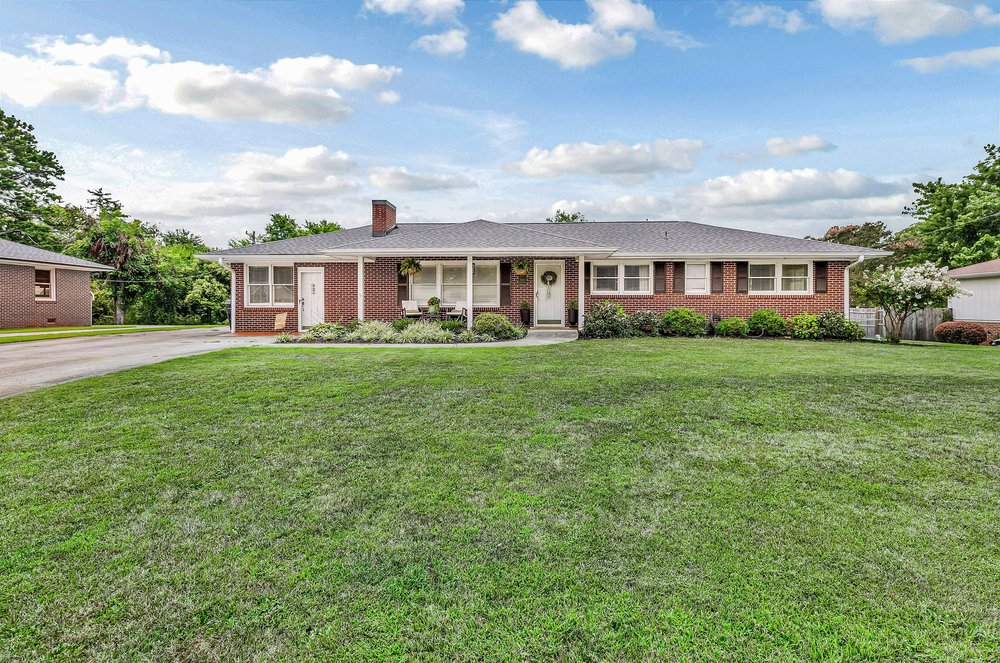 2310 Hannah Road Anderson, SC 29621 - Photo 1 of 32 A classic brick ranch home sits invitingly behind a verdant, well-maintained lawn.