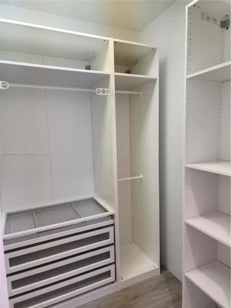 a view of closet area with empty racks