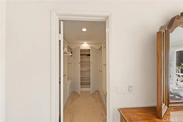 a view of a hallway with wooden floor and closet