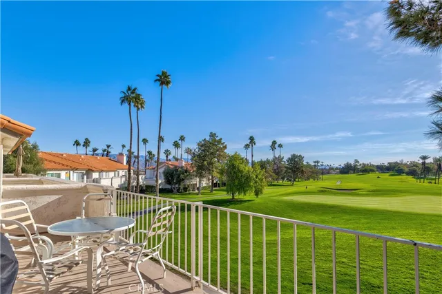 a view of a balcony with table and chairs