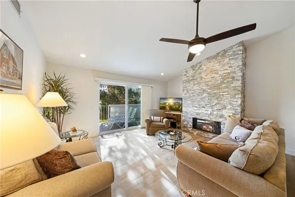 a living room with furniture fireplace and a flat screen tv