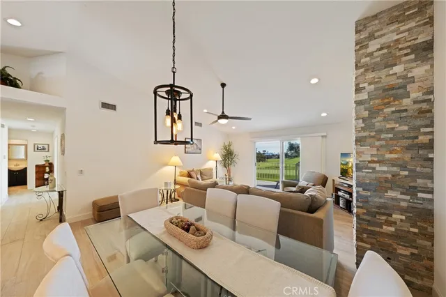 a living room with furniture a window and a chandelier