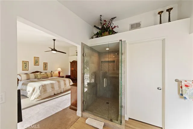 a en suite bathroom with a granite countertop sink and a mirror