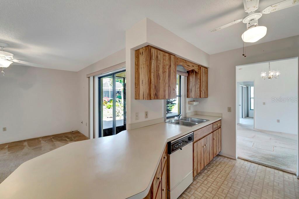 5861 Adams Road Venice, FL 34293 - Photo 23 of 51 Breakfast Bar blends Kitchen and Family Rooms