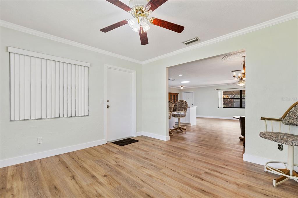 1855 Pine Tree Drive Edgewater, FL 32141 - Photo 13 of 26 a view of empty room with wooden floor and fan
