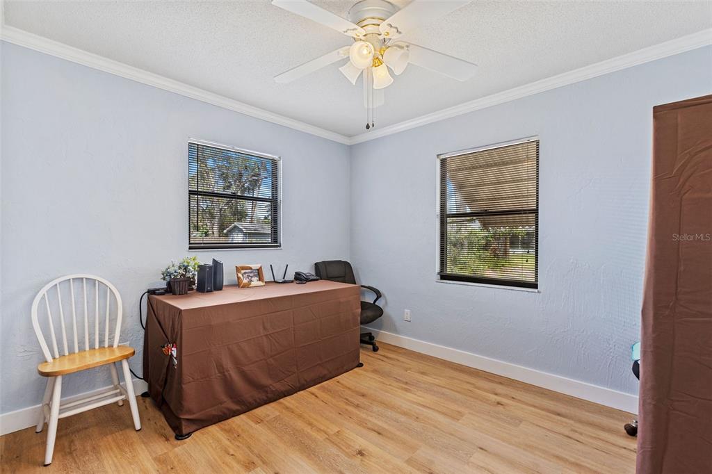 1855 Pine Tree Drive Edgewater, FL 32141 - Photo 17 of 26 a bedroom with a bed and a chandelier