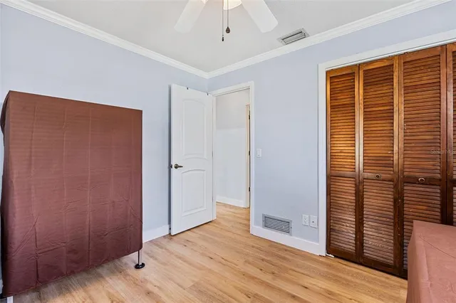 a view of a livingroom with wooden floor and a ceiling fan