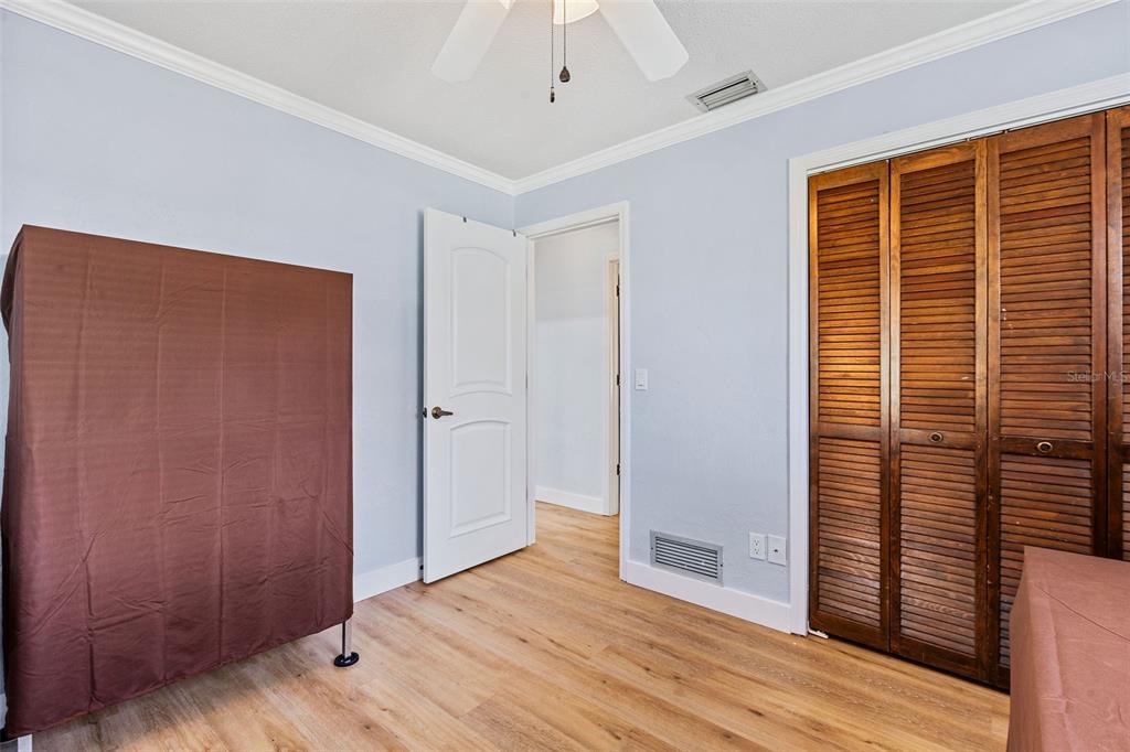 1855 Pine Tree Drive Edgewater, FL 32141 - Photo 18 of 26 a view of a livingroom with wooden floor and a ceiling fan