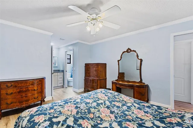 a bedroom with bed and wooden floor