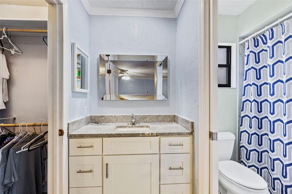 1855 Pine Tree Drive Edgewater, FL 32141 - Photo 22 of 26 a bathroom with a granite countertop sink and a mirror