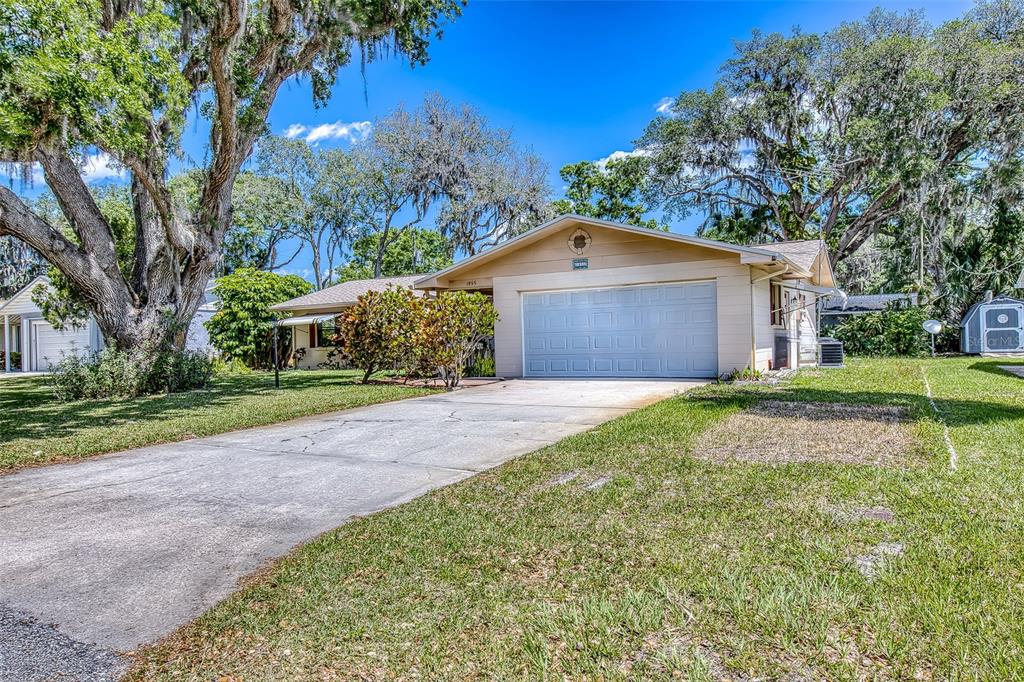 1855 Pine Tree Drive Edgewater, FL 32141 - Photo 3 of 26 a front view of a house with garden