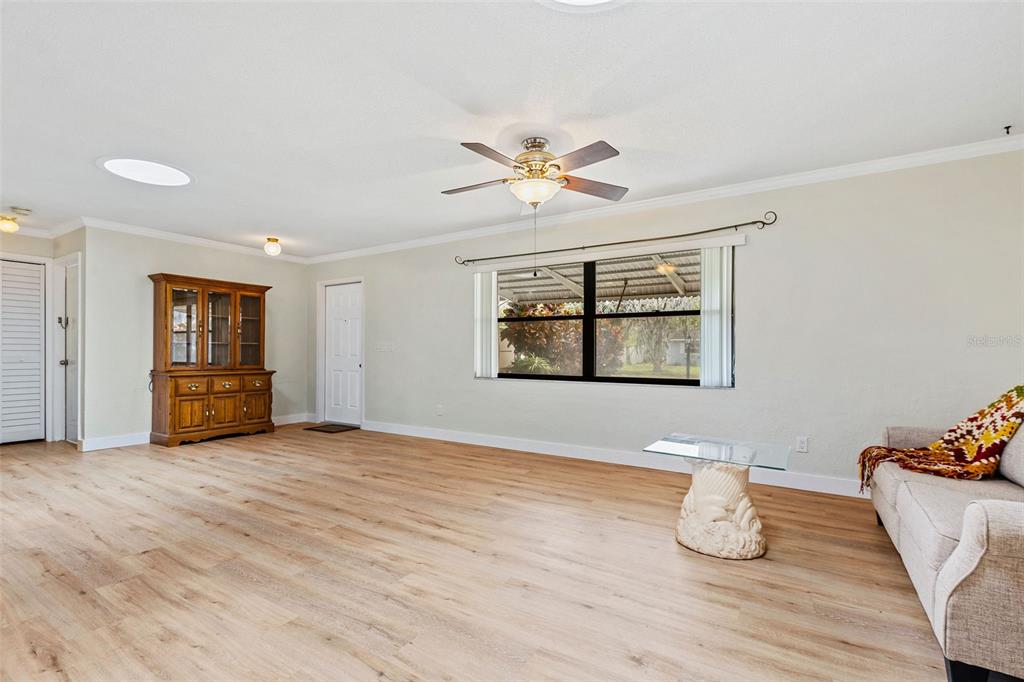 1855 Pine Tree Drive Edgewater, FL 32141 - Photo 5 of 26 a view of an empty room with window and wooden floor