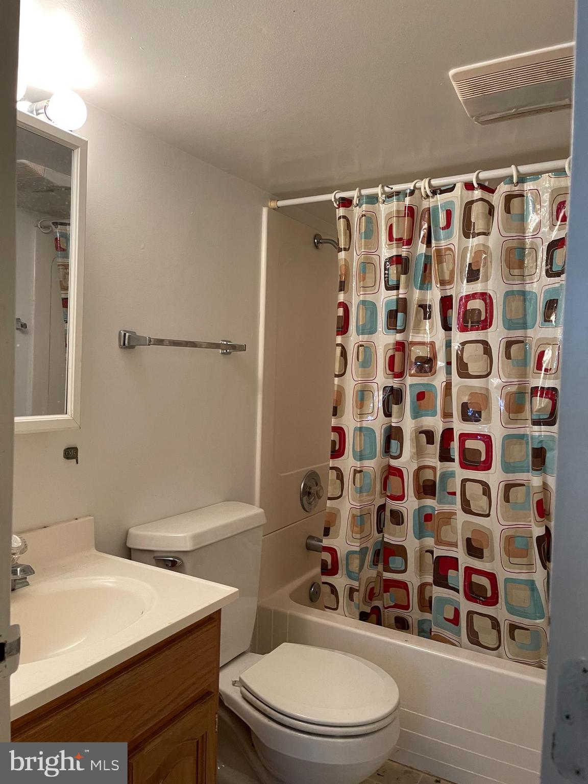 7968 Telegraph Road Severn, MD 21144 - Photo 21 of 26 a bathroom with a sink a toilet and shower curtain