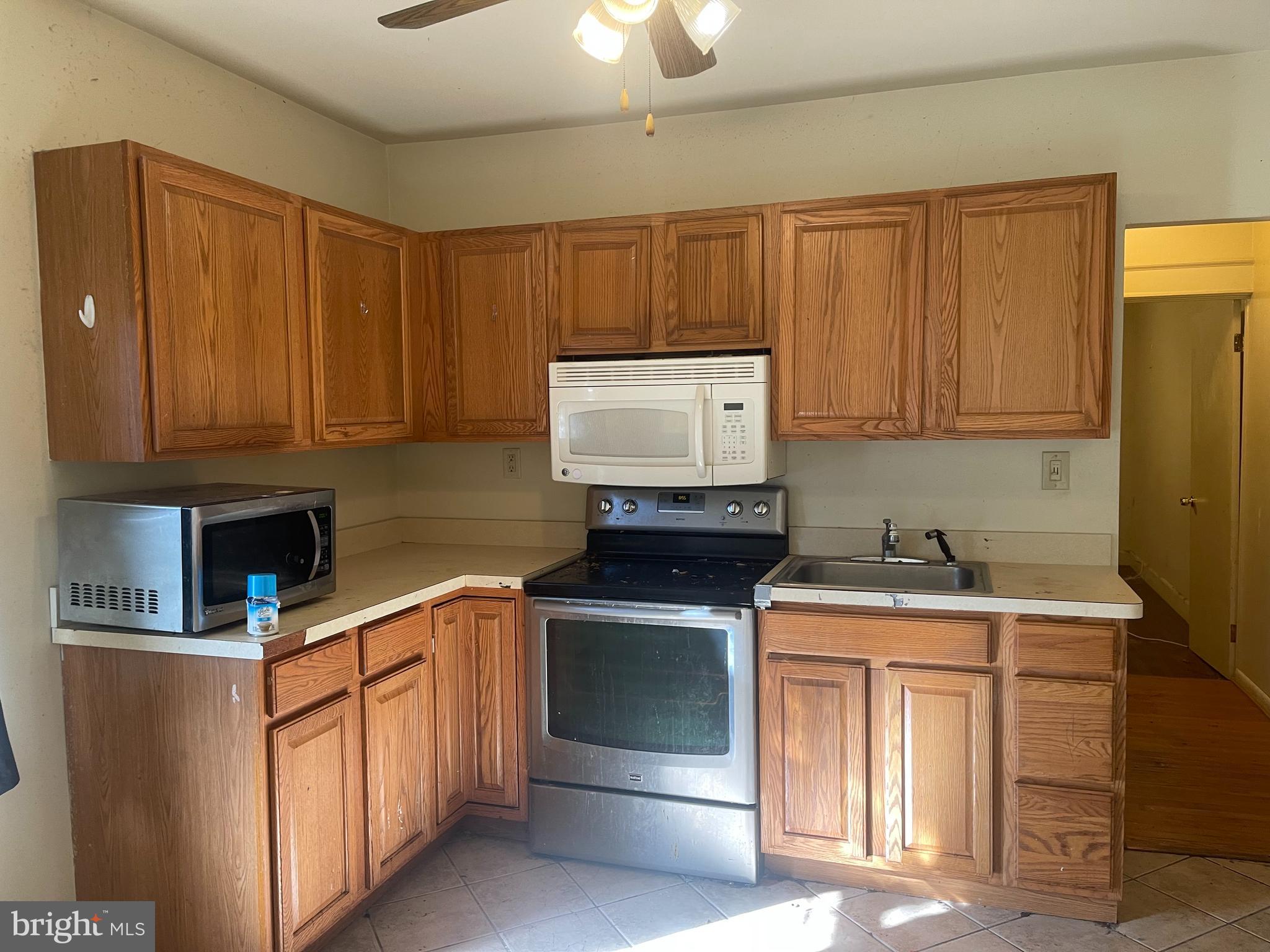 7968 Telegraph Road Severn, MD 21144 - Photo 4 of 26 a kitchen with stainless steel appliances granite countertop a sink and a microwave