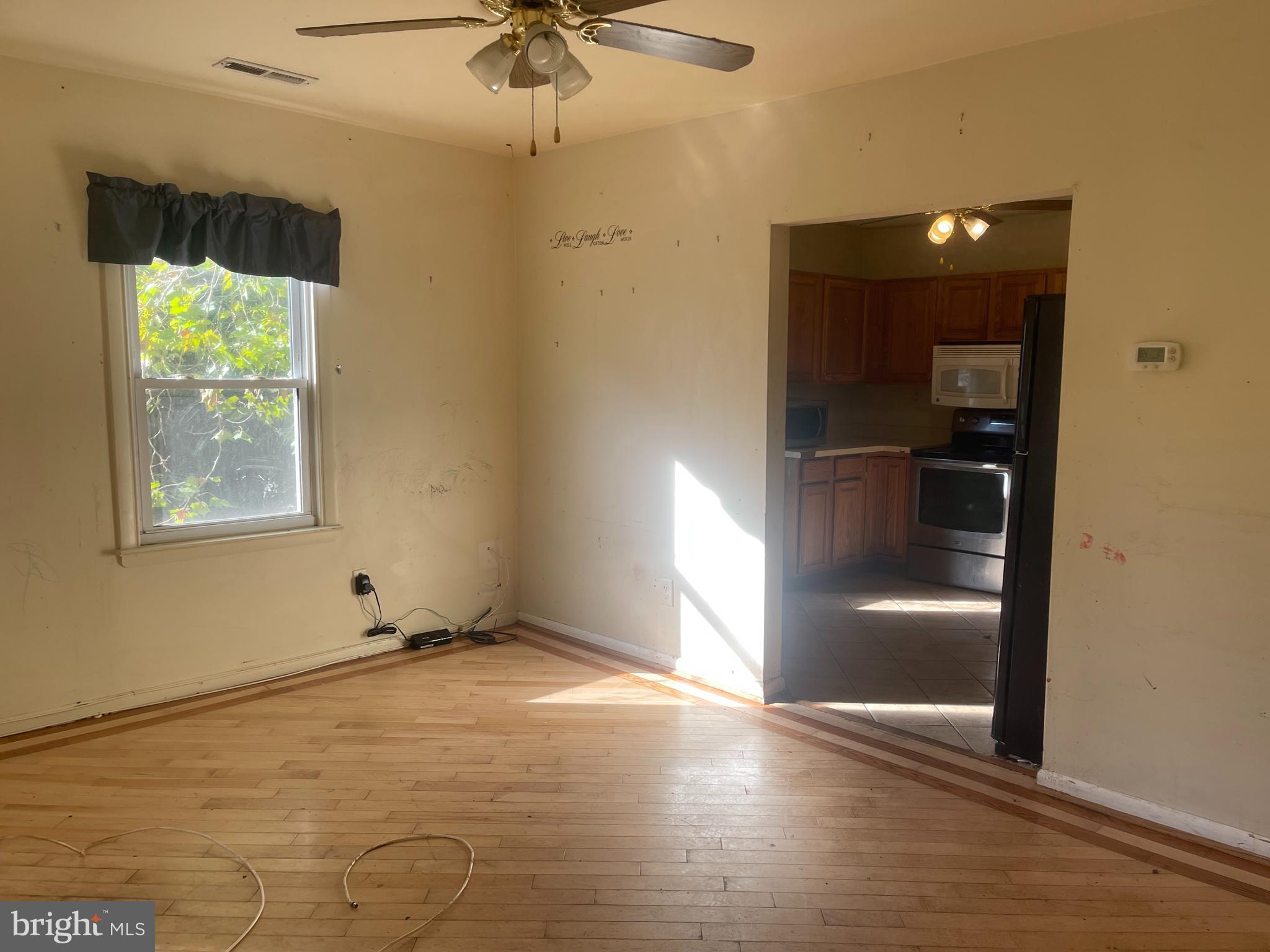 7968 Telegraph Road Severn, MD 21144 - Photo 5 of 26 wooden floor in an empty room with a window
