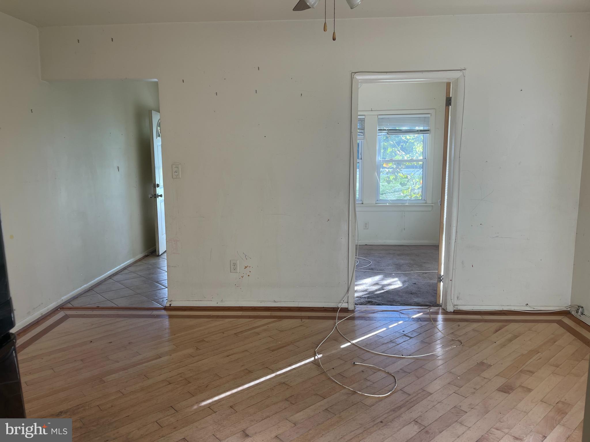 7968 Telegraph Road Severn, MD 21144 - Photo 6 of 26 an empty room with wooden floor and windows