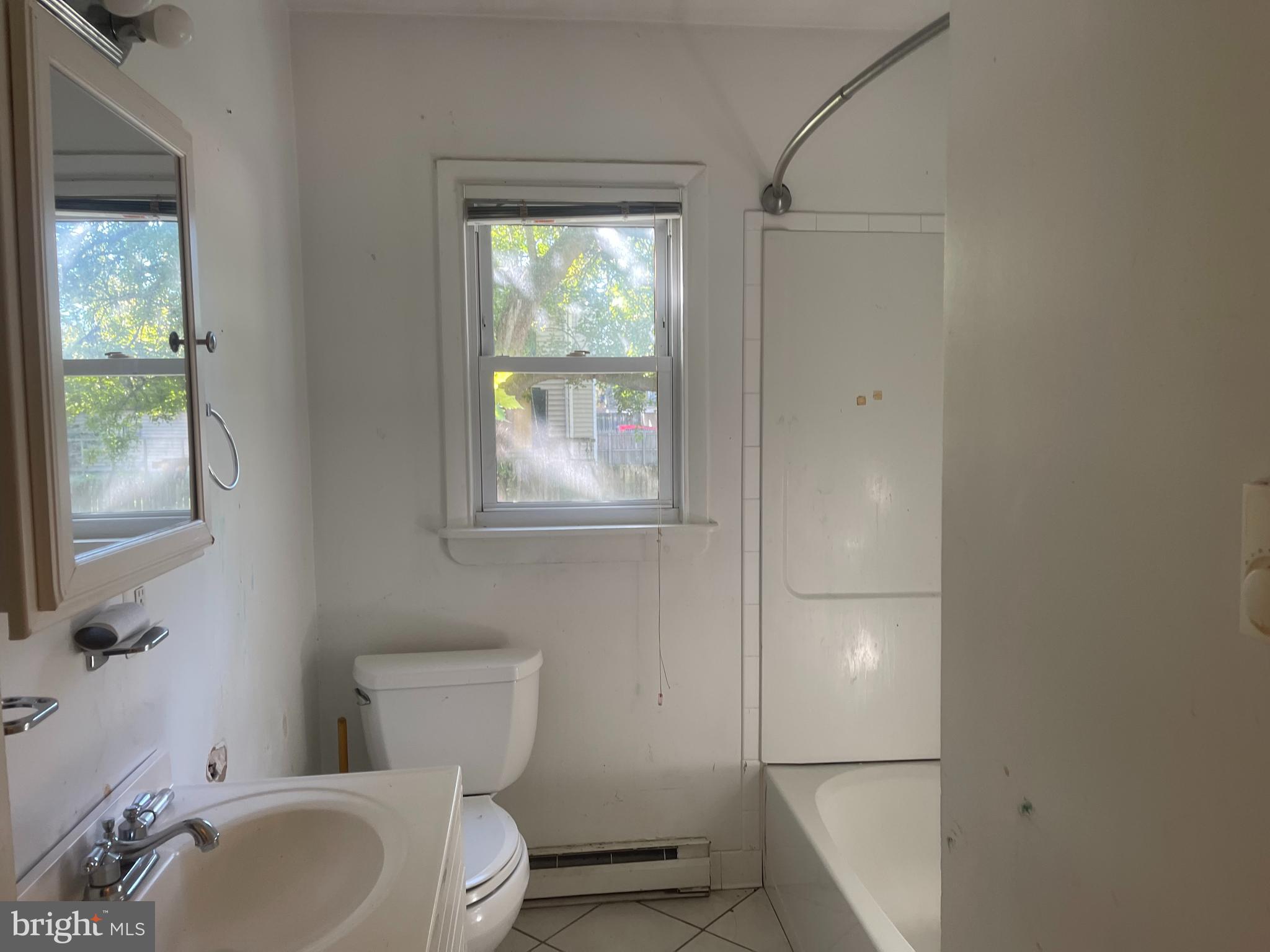 7968 Telegraph Road Severn, MD 21144 - Photo 8 of 26 a bathroom with a toilet sink and mirror