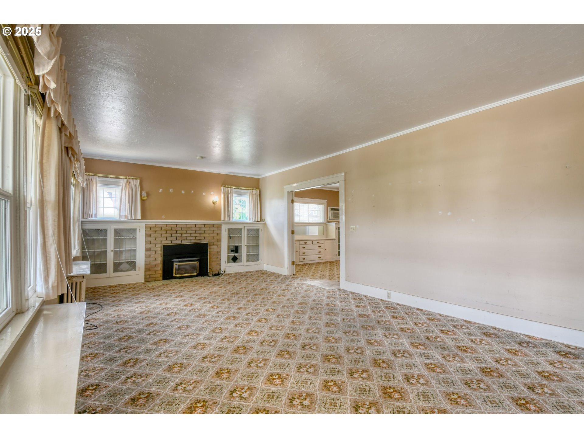 815 Northwest Bailey Avenue Pendleton, OR 97801 - Photo 6 of 44 a view of an empty room with a fireplace and a window