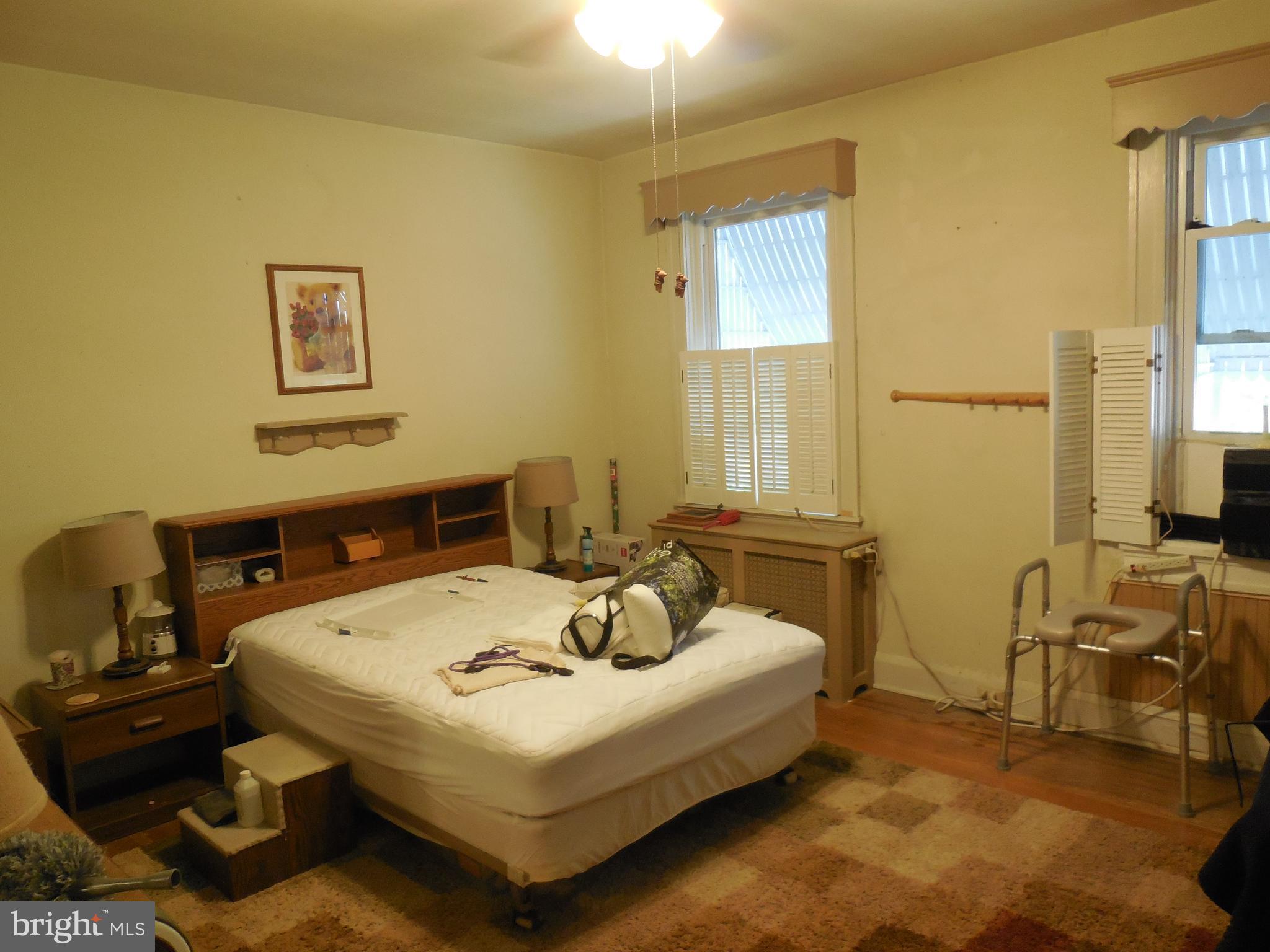 3314 Kenyon Avenue Baltimore, MD 21213 - Photo 11 of 21 a bedroom with a bed and wooden floor
