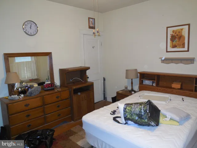 a bedroom with a bed and a dresser