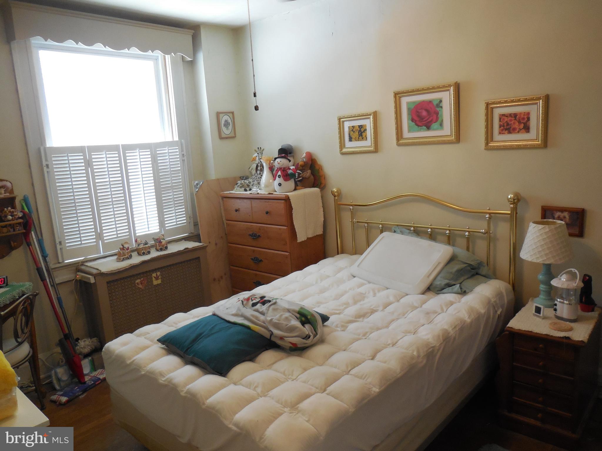 3314 Kenyon Avenue Baltimore, MD 21213 - Photo 13 of 21 a bedroom with a bed and wooden floor